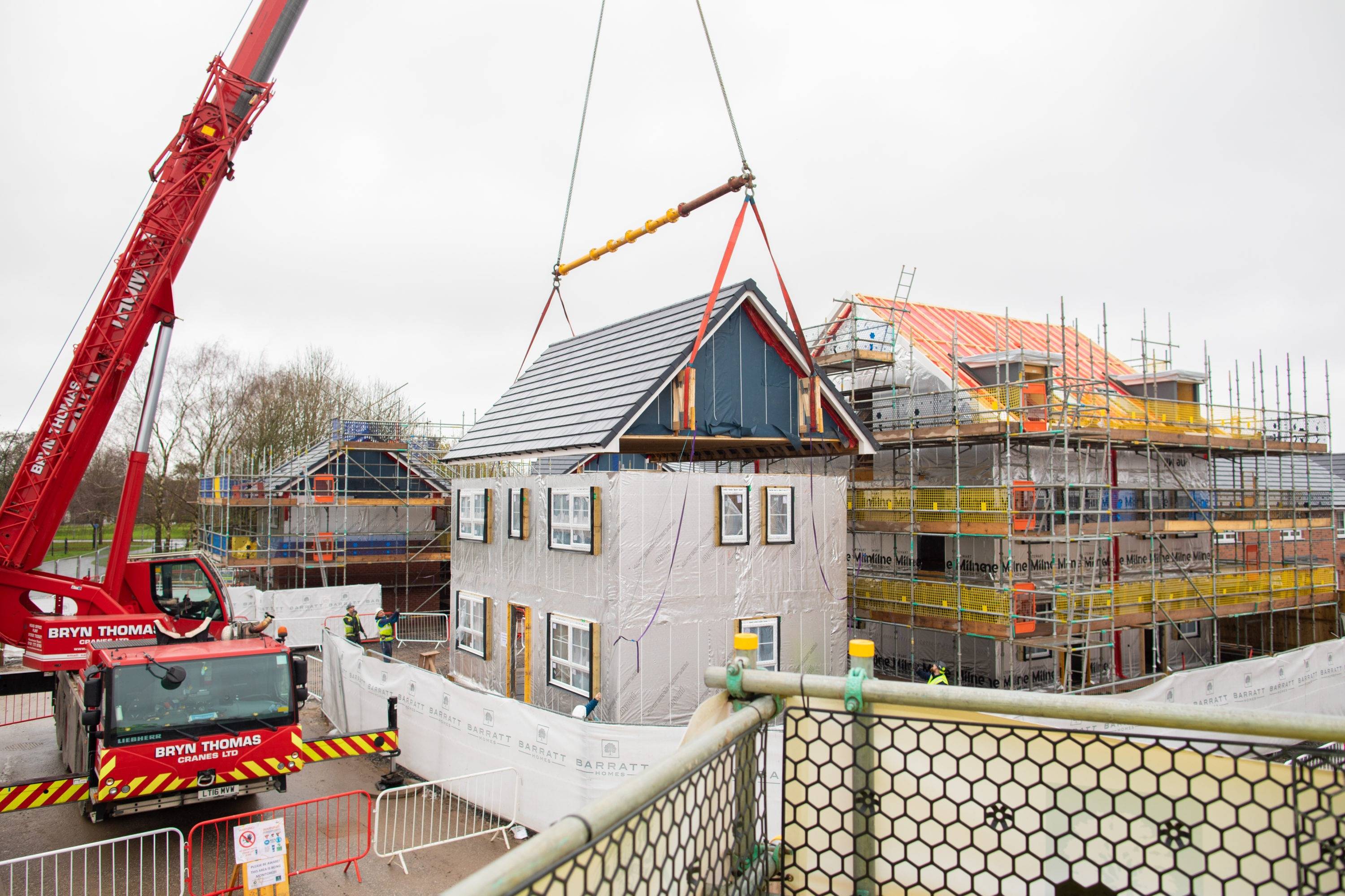 A roof being placed on a building