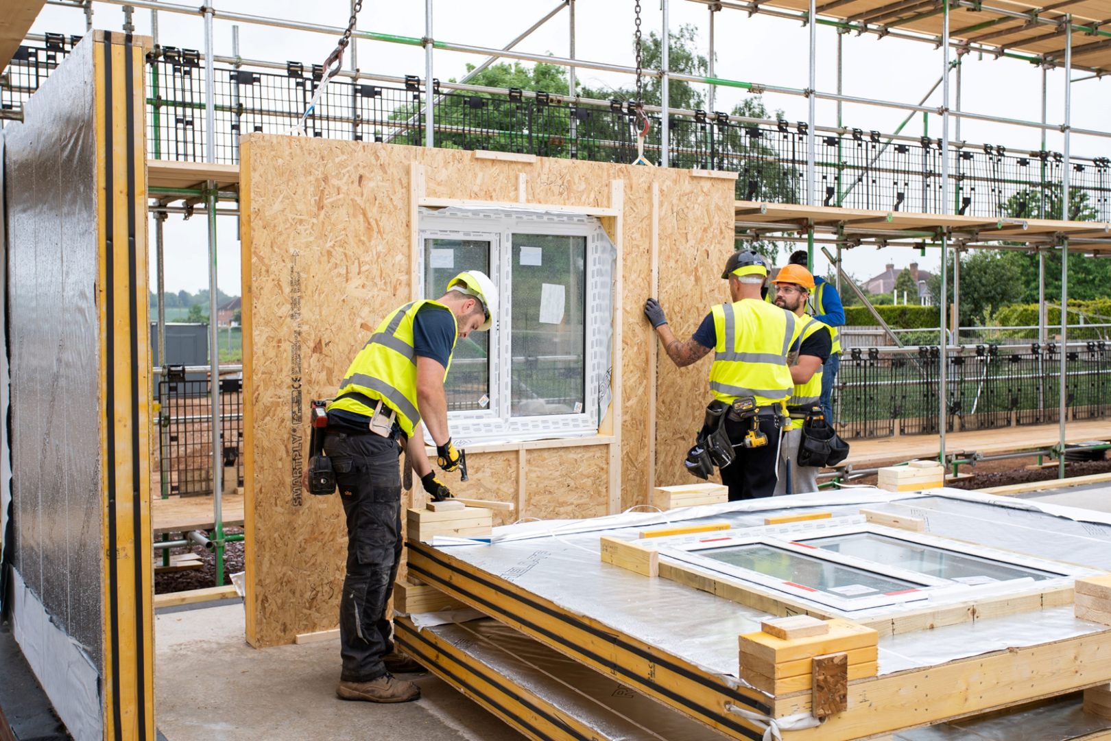 Workers installing Donaldson Timber Systems timber frame housing